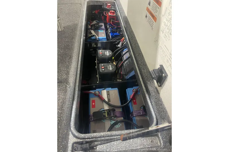 Slide: The Image of 2020 Ranger Z518 boat battery compartment with multiple batteries and wiring. - 2