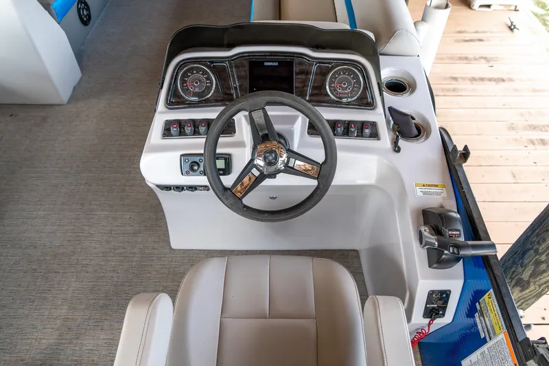 Slide: The Image of Cockpit view of 2021 Godfrey Sweetwater 2286 C boat with steering wheel and controls. - 11