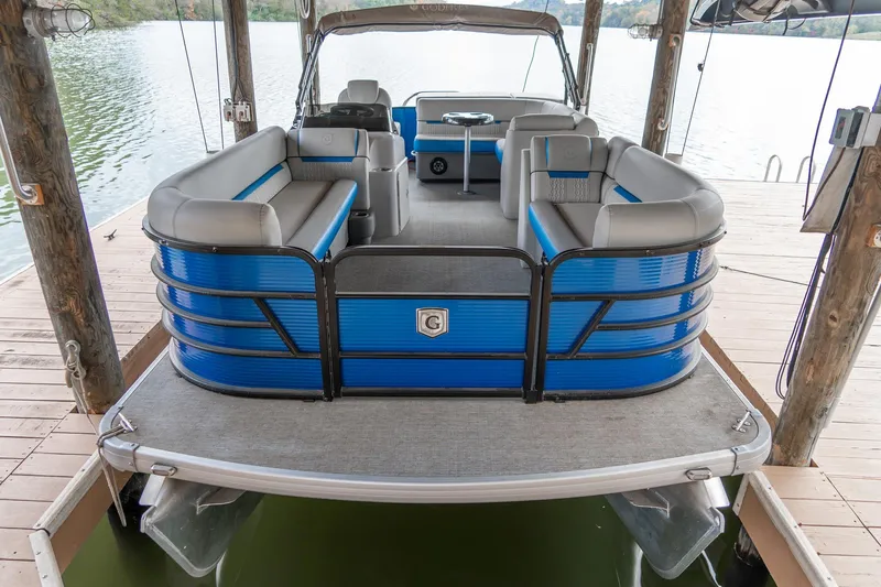 Slide: The Image of 2021 Godfrey Sweetwater 2286 C pontoon boat docked on a serene lake. - 17