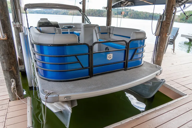 Slide: The Image of 2021 Godfrey Sweetwater 2286 C pontoon boat docked on a lake. - 4