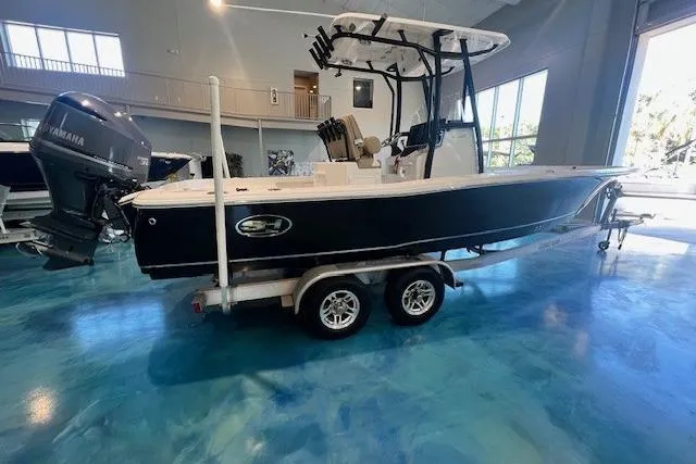 Slide: The Image of 2017 Sea Hunt BX 25 BR boat on trailer in showroom with Yamaha outboard motor. - 1