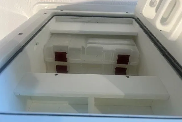 Slide: The Image of 2017 Sea Hunt BX 25 BR boat storage compartment, open and empty. - 11