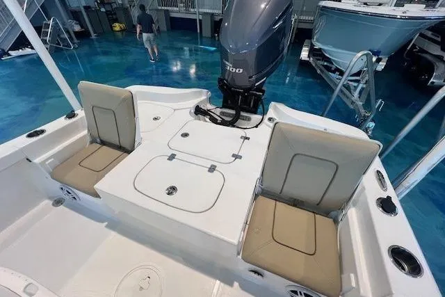Slide: The Image of 2017 Sea Hunt BX 25 BR boat interior with seating and outboard motor in showroom. - 15