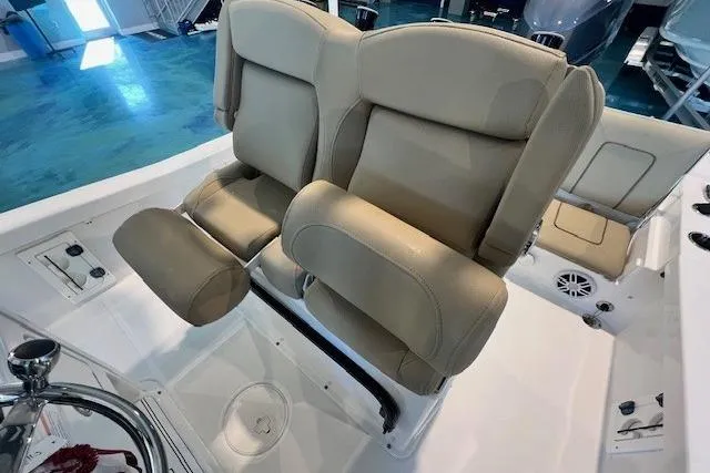 Slide: The Image of 2017 Sea Hunt BX 25 BR boat interior with beige seating and steering wheel. - 16