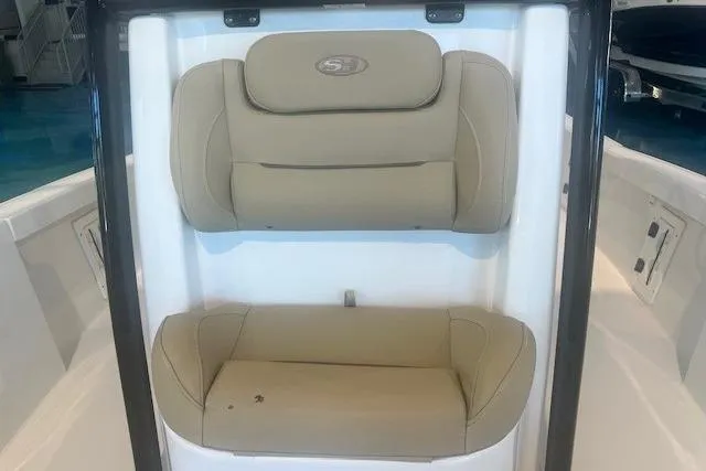 Slide: The Image of 2017 Sea Hunt BX 25 BR boat with beige cushioned seating. - 17