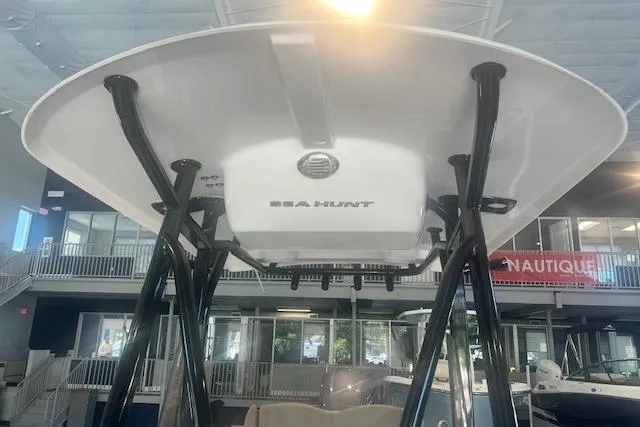 Slide: The Image of 2017 Sea Hunt BX 25 BR boat, interior view, showcasing T-top and support structure. - 3