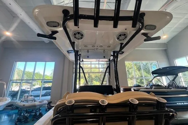 Slide: The Image of 2017 Sea Hunt BX 25 BR boat interior with rod holders and speakers in showroom. - 4