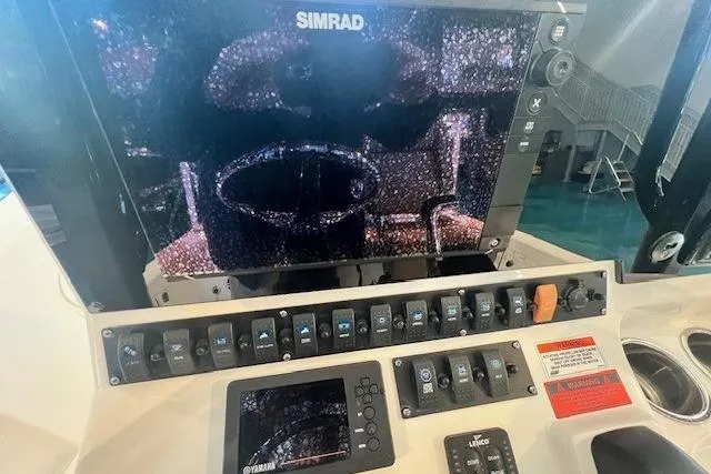 Slide: The Image of Control panel of 2017 Sea Hunt BX 25 BR boat with Simrad display and switches. - 5