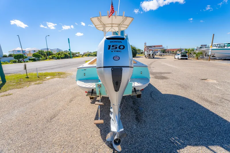 Slide: The Image of Oyster Bay 23 boat with Honda 150 VTEC engine, parked on sunny day, 2005 model. - 11