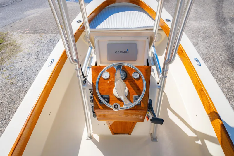 Slide: The Image of 2005 Oyster Bay 23 boat helm with Garmin navigation system and wooden steering wheel. - 16