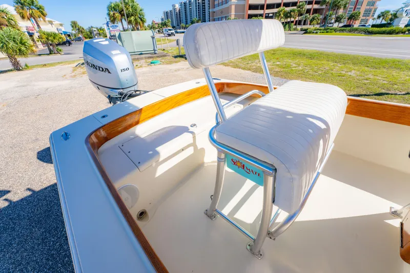 Slide: The Image of 2005 Oyster Bay 23 boat with Honda 150 engine, white seating, and wooden trim. - 20