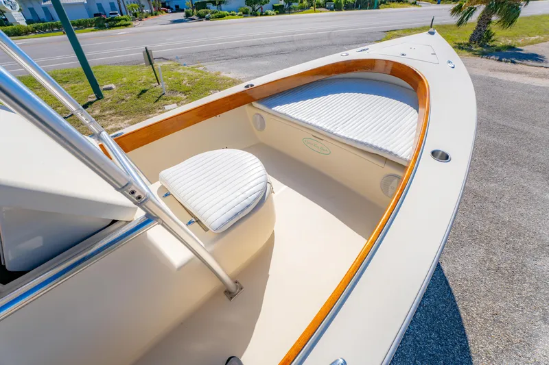 Slide: The Image of 2005 Oyster Bay 23 boat interior with white seating and wooden trim. - 25