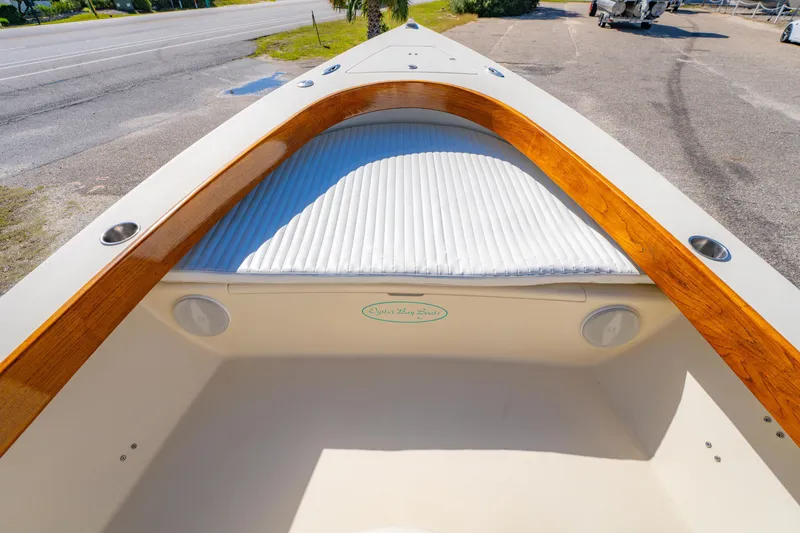 Slide: The Image of Oyster Bay 23 boat interior with wood trim, 2005 model, parked on roadside. - 28
