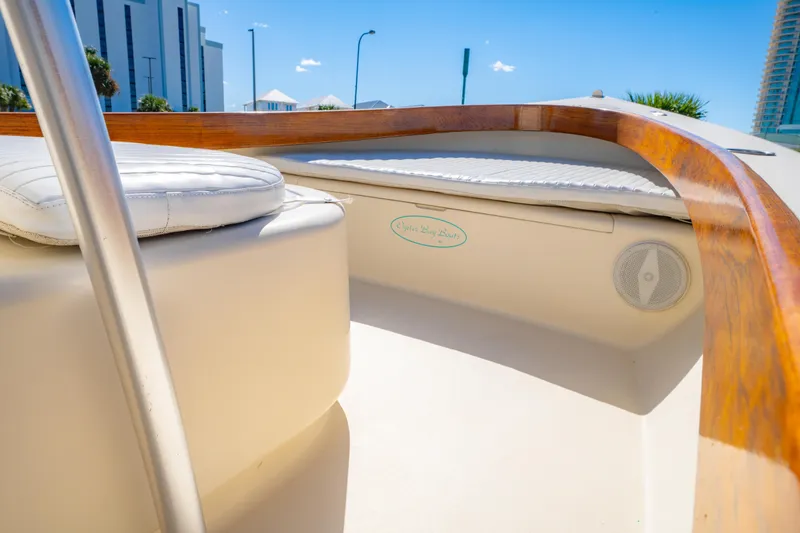 Slide: The Image of 2005 Oyster Bay 23 boat interior with wooden trim and cushioned seating. - 31