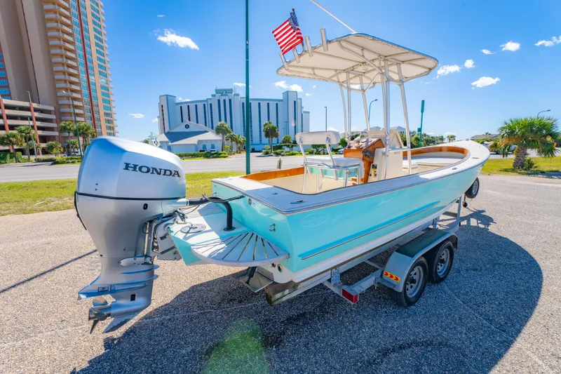 Slide: The Image of 2005 Oyster Bay 23 boat with Honda outboard motor on trailer, sunny day. - 5