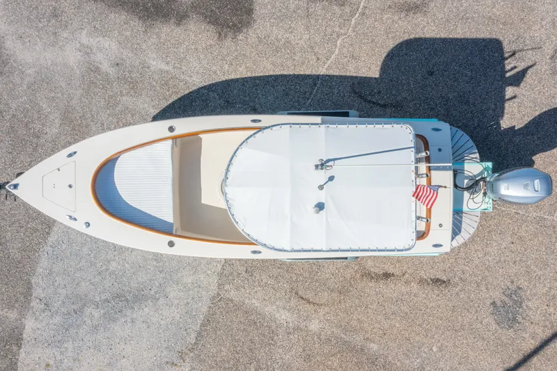 Slide: The Image of Aerial view of 2005 Oyster Bay 23 boat with American flag and outboard motor. - 6