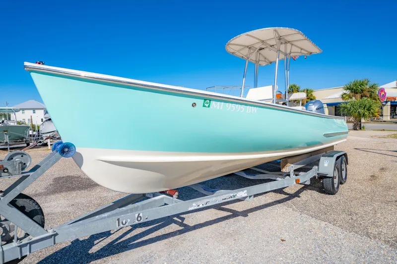 Slide: The Image of 2005 Oyster Bay 23 boat on trailer, light blue hull, sunny day. - 8