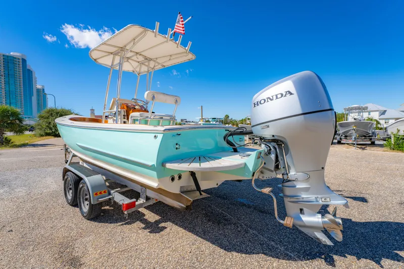 Slide: The Image of 2005 Oyster Bay 23 boat with Honda outboard motor on trailer, sunny day. - 9