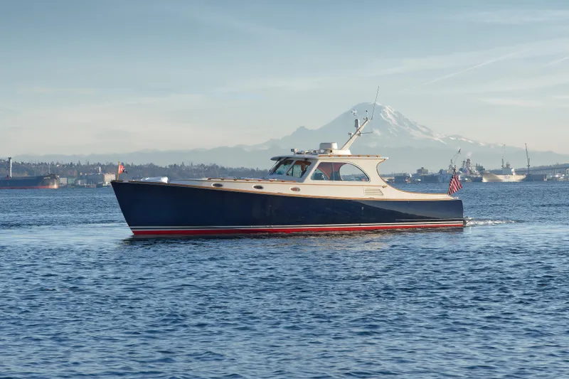 The Image of Hinckley Talaria 44 yacht cruising on water with mountain backdrop, 2001 model. - 0