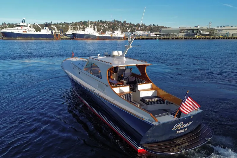 Slide: The Image of Hinckley Talaria 44 yacht from 2001 cruising in a harbor with American flag. - 11