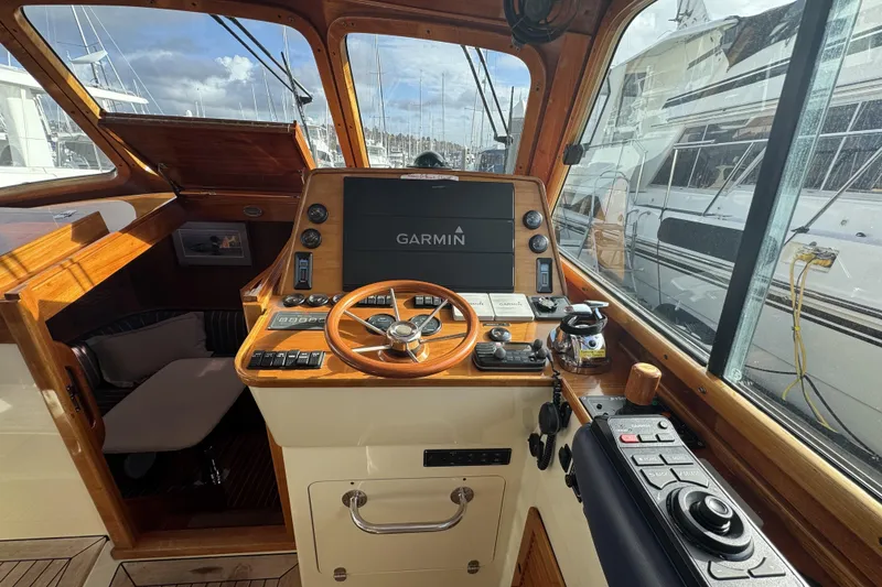 Slide: The Image of Helm of 2001 Hinckley Talaria 44 yacht with Garmin navigation system and wooden accents. - 13