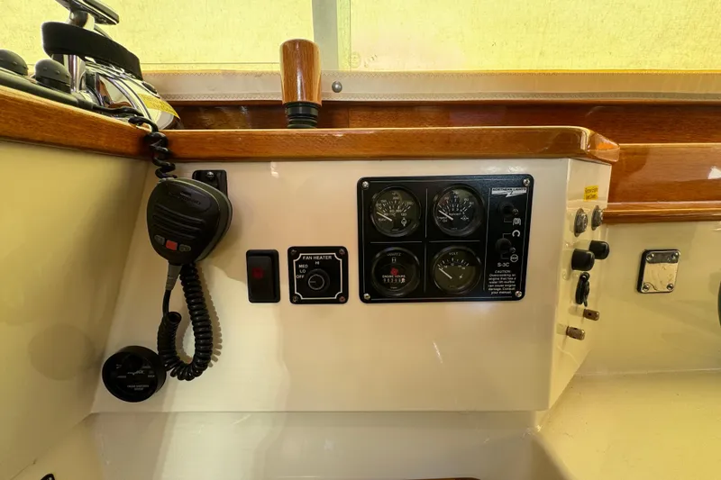 Slide: The Image of Control panel of a 2001 Hinckley Talaria 44 boat with gauges and radio. - 14