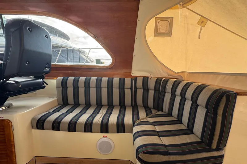 Slide: The Image of Interior of 2001 Hinckley Talaria 44 yacht with striped seating and helm chair. - 15