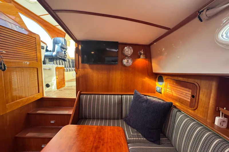 Slide: The Image of Interior of 2001 Hinckley Talaria 44 yacht with cozy seating and wooden finishes. - 22