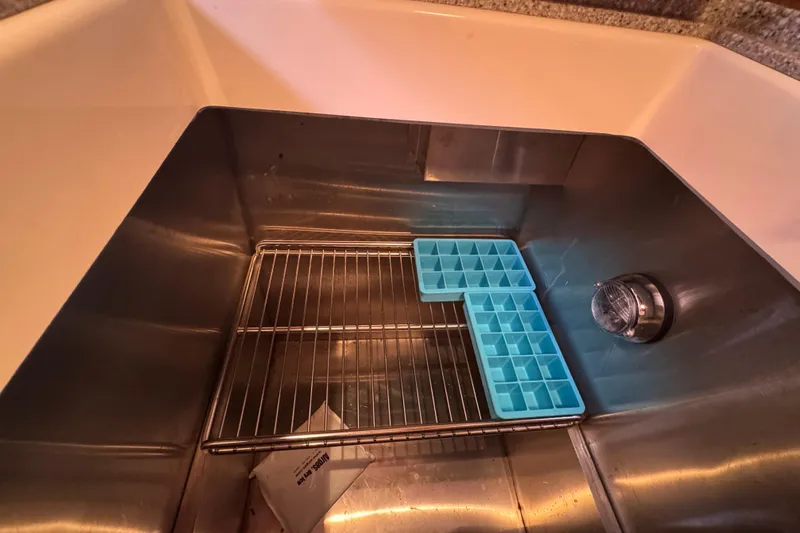 Slide: The Image of Stainless steel sink with ice tray and rack on a Hinckley Talaria 44 yacht. - 30