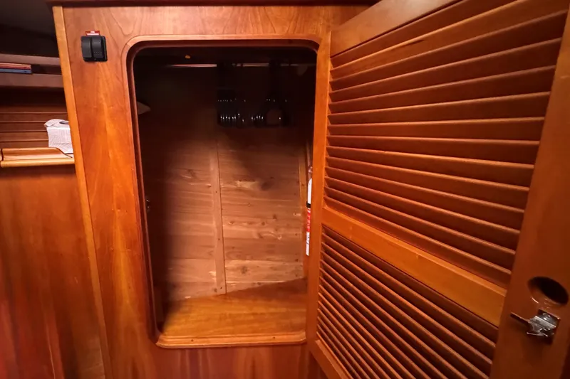 Slide: The Image of Wooden interior of 2001 Hinckley Talaria 44 yacht with open louvered door. - 34