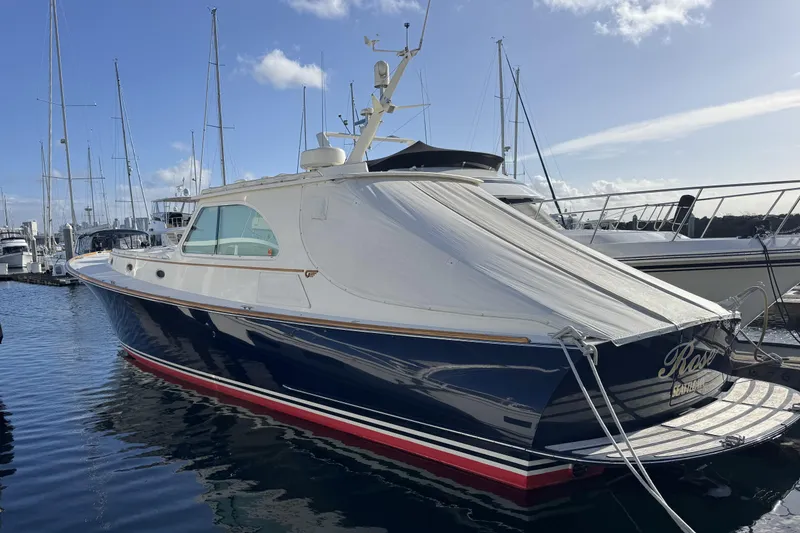 Slide: The Image of 2001 Hinckley Talaria 44 yacht docked at marina under clear blue sky. - 56