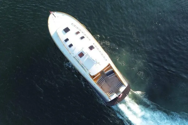 Slide: The Image of Aerial view of 2001 Hinckley Talaria 44 yacht cruising on open water. - 59