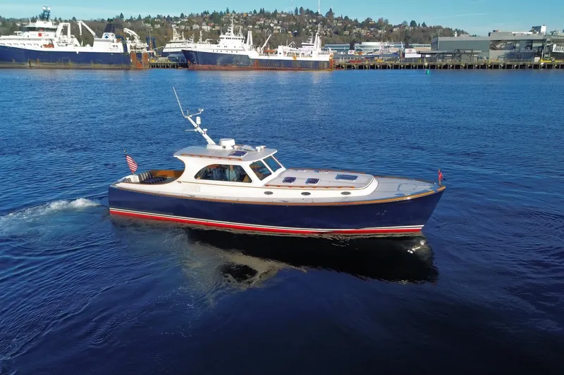 Slide: The Image of 2001 Hinckley Talaria 44 yacht cruising in a scenic harbor setting. - 63