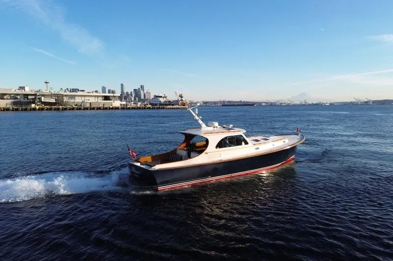 Slide: The Image of 2001 Hinckley Talaria 44 yacht cruising near city skyline on a sunny day. - 9