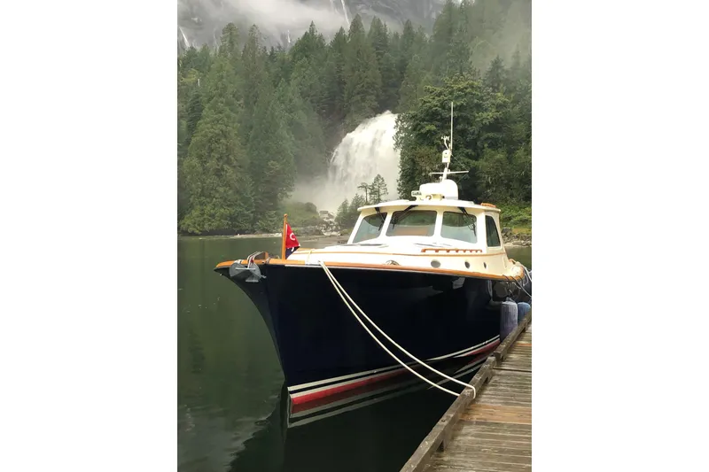 Slide: The Image of Hinckley Talaria 44 yacht docked near a scenic waterfall, 2001 model. - 10