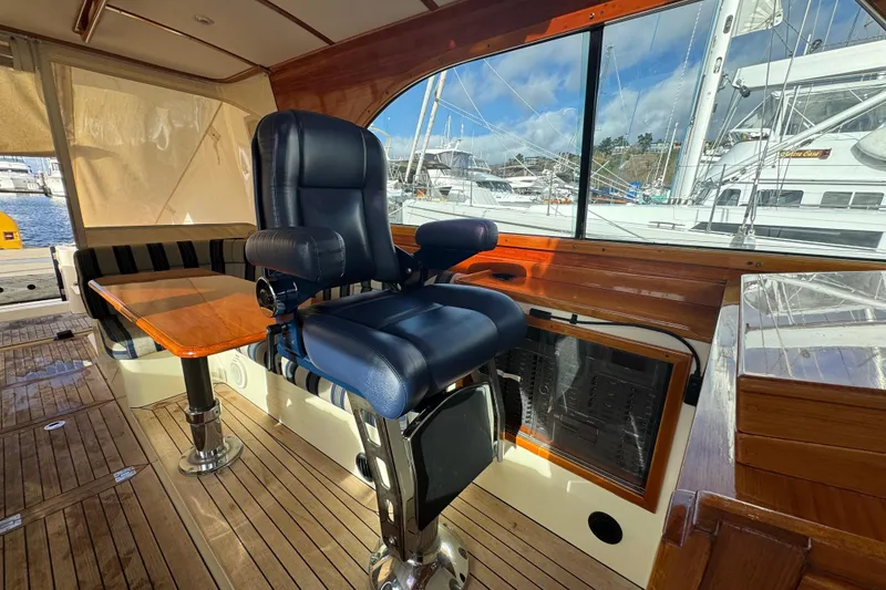 Slide: The Image of Interior of 2001 Hinckley Talaria 44 yacht with leather captain's chair and wooden accents. - 17