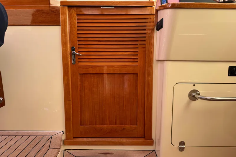 Slide: The Image of Wooden cabin door on a 2001 Hinckley Talaria 44 yacht interior. - 20