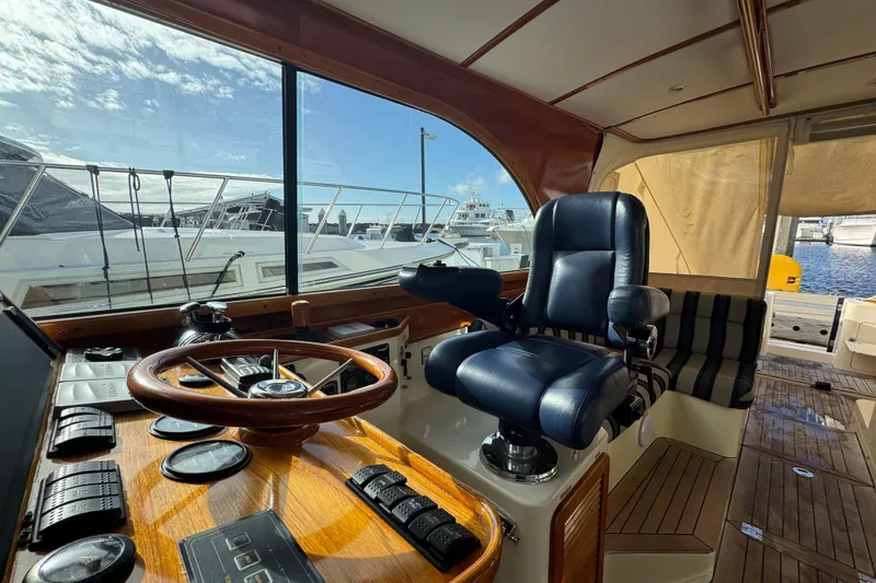 Slide: The Image of Interior view of 2001 Hinckley Talaria 44 yacht cockpit with steering wheel and captain's chair. - 4