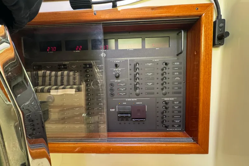 Slide: The Image of Electrical control panel on a 2001 Hinckley Talaria 44 yacht, featuring various switches and displays. - 40
