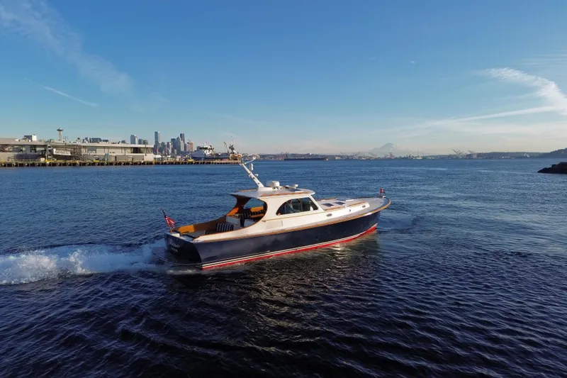 Slide: The Image of 2001 Hinckley Talaria 44 cruising near a city skyline on a sunny day. - 64