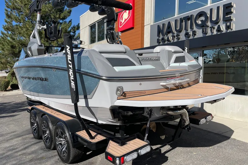 Slide: The Image of 2020 Nautique Super Air Nautique G25 boat on trailer outside dealership. - 3