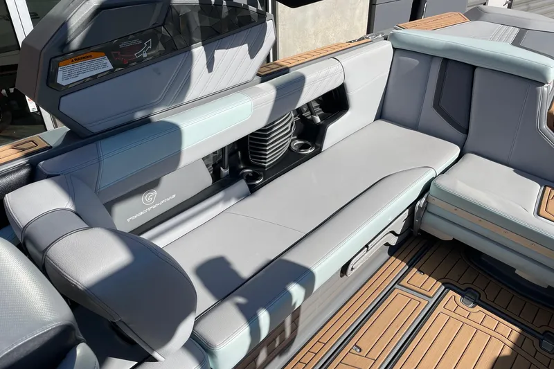 Slide: The Image of 2020 Nautique Super Air Nautique G25 interior with gray seating and teak flooring. - 7