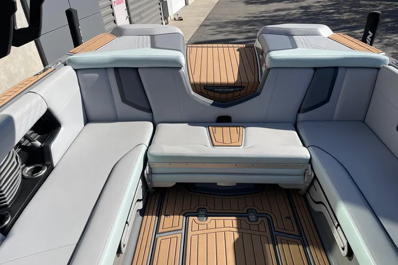 Slide: The Image of 2020 Nautique Super Air Nautique G25 interior with sleek seating and teak flooring. - 8