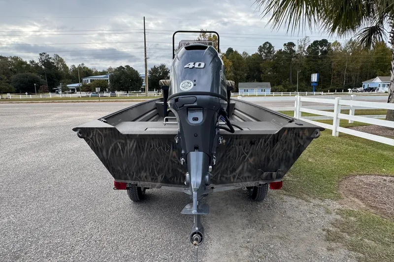 Slide: The Image of 2026 Alweld 1656VV Marsh Console CC boat with 40HP motor, parked outdoors. - 4