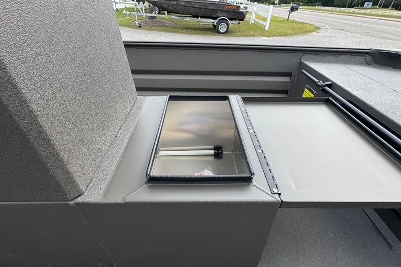 Slide: The Image of 2026 Alweld 1656VV Marsh Console CC boat interior with storage compartment open. - 6