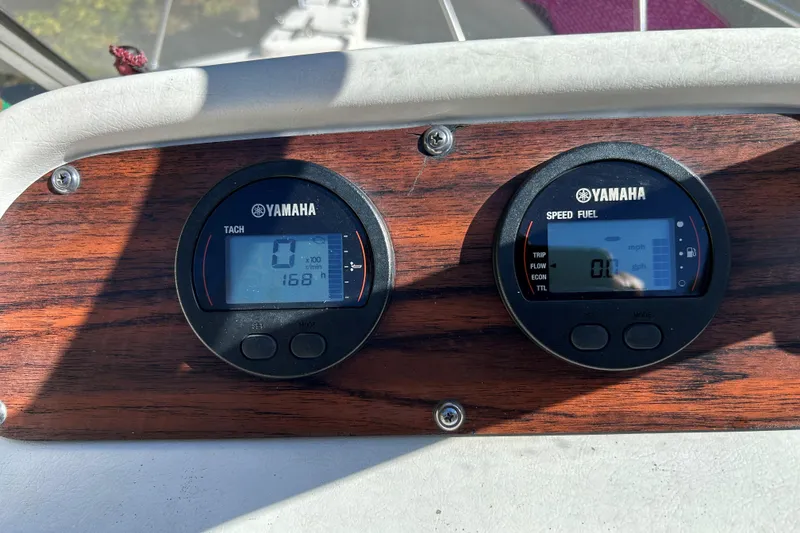 Slide: The Image of Yamaha gauges on 1998 Grady-White Seafarer 226 boat dashboard, displaying tachometer and speed fuel data. - 10