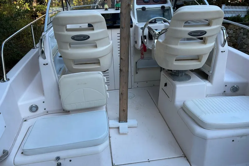 Slide: The Image of 1998 Grady-White Seafarer 226 boat interior with white seating and steering console. - 11