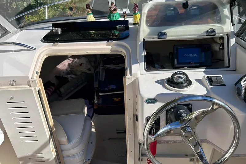 Slide: The Image of 1998 Grady-White Seafarer 226 boat cockpit with Garmin navigation system and cabin entrance. - 13