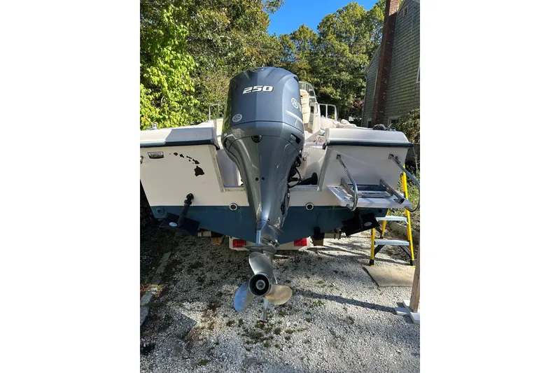Slide: The Image of 1998 Grady-White Seafarer 226 boat with powerful outboard motor, parked outdoors. - 16