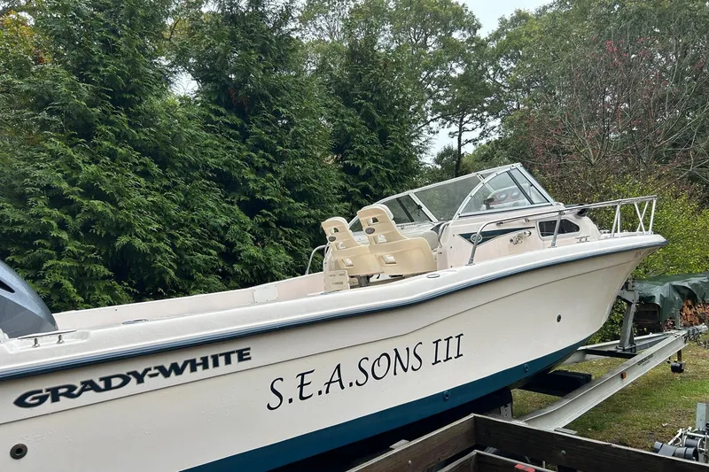 Slide: The Image of 1998 Grady-White Seafarer 226 boat named S.E.A. Sons III on trailer, surrounded by trees. - 3